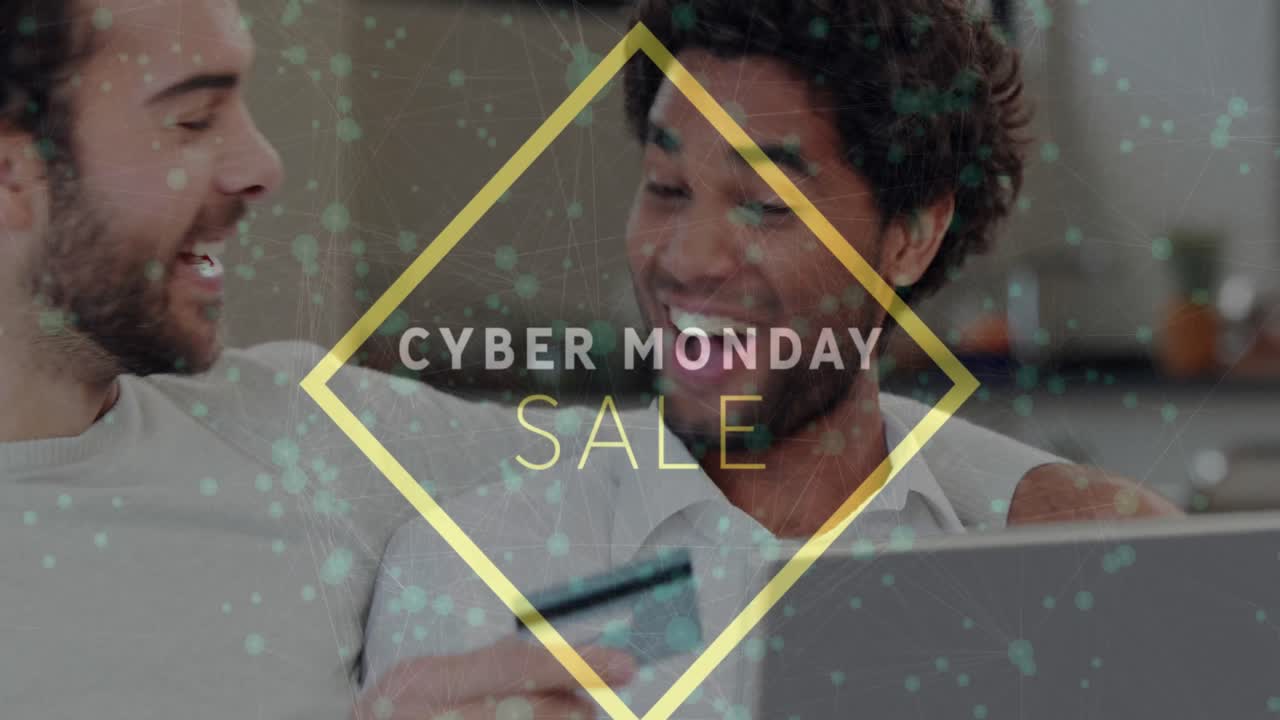 Animation of cyber monday sale over happy diverse gay couple with laptop doing online shopping