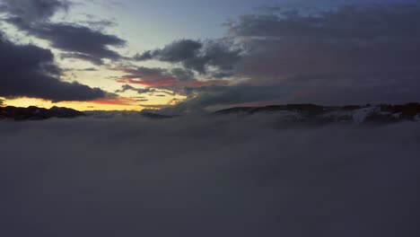 drone flying over clouds and fog in zakopane near tatra mountains at sunset in poland