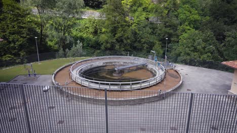 construction for wastewater treatment in outskirts of city in summer day near forest, top panoramic view