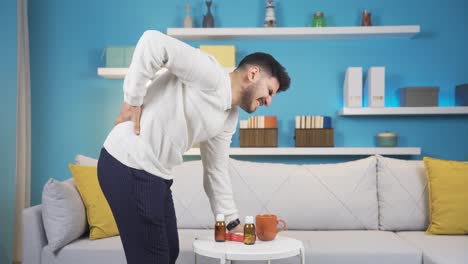 young man with backache while lifting the table.