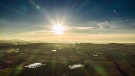 beautifull warm sunset in the bohemian countryside. the dimming disk of the sun retreating from the sky, casting its last warm light on the valley and forest below, filling the scene with a warm glow.