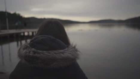 woman sitting by the lake