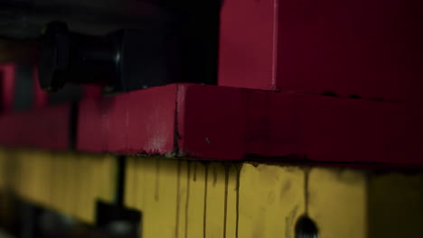 Close-up-of-a-big-metal-block-being-lifted-by-a-forklift-in-a-warehouse-next-to-a-factory