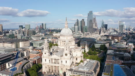 Aerial-view-of-Saint-Pauls-Cathedral,-old-baroque-religious-building.-Group-of-tall-modern-office-buildings-in-background.-London,-UK