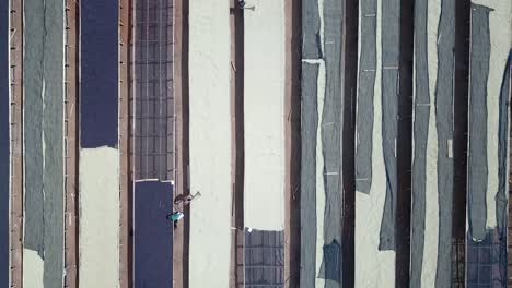 Beautiful-aerial-of-coffee-processing-scene,-beans-are-drying-outside