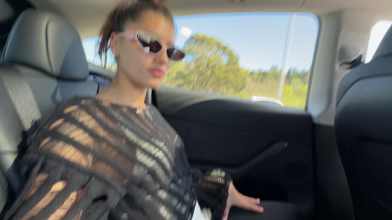 Woman in a Tesla Backseat
