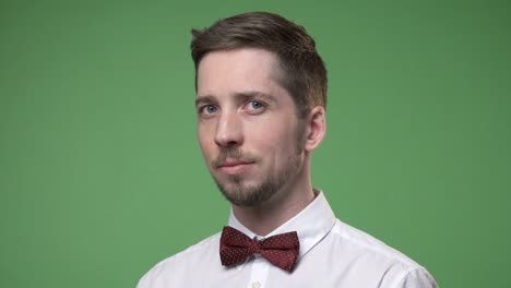 young man student wearing a white shirt with a bow tie, chroma key green screen background
