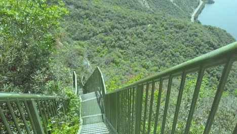 lake garda railing reveals busatte-tempesta pathway with metal railing, sky, water, waves, mountains, and clouds