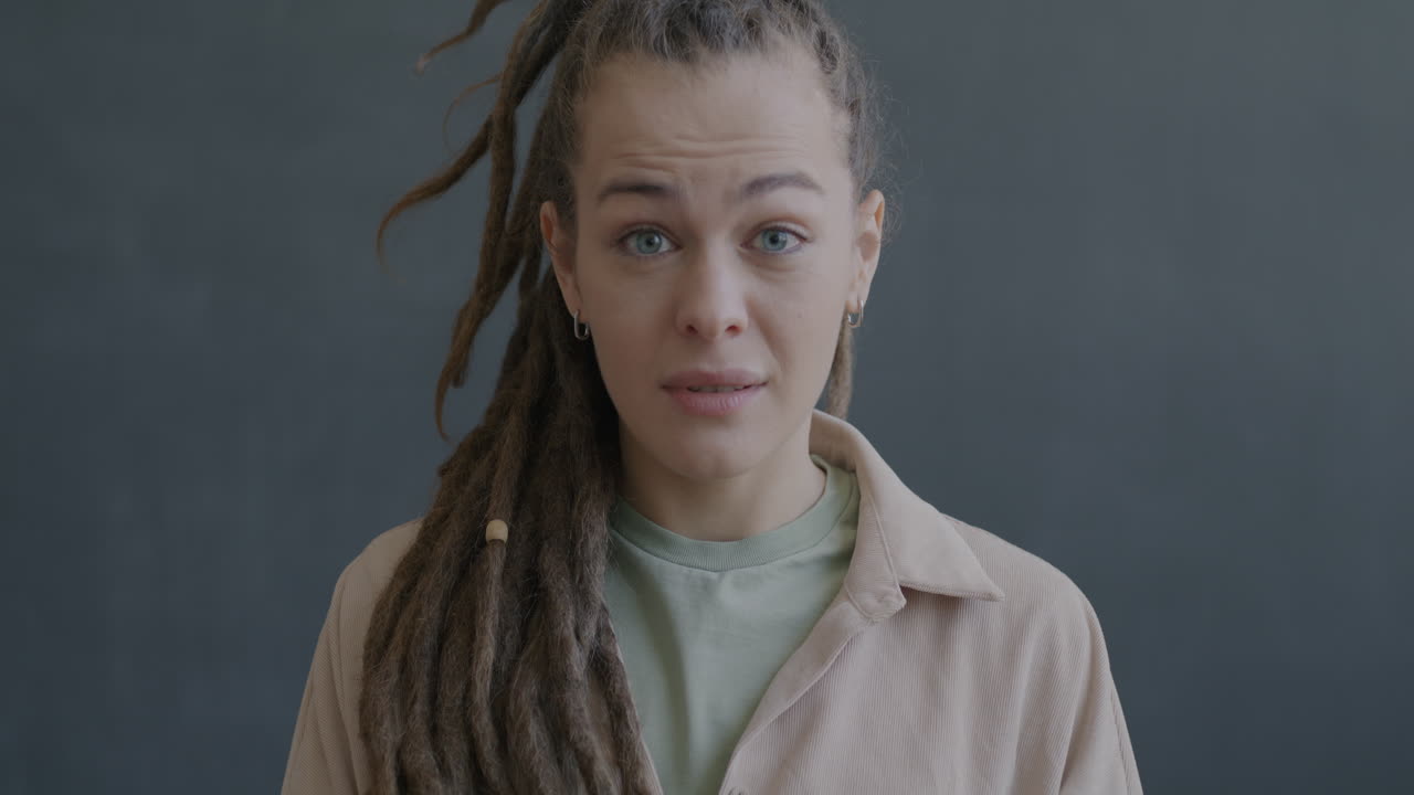 Woman with Dreadlocks Expressing Concern