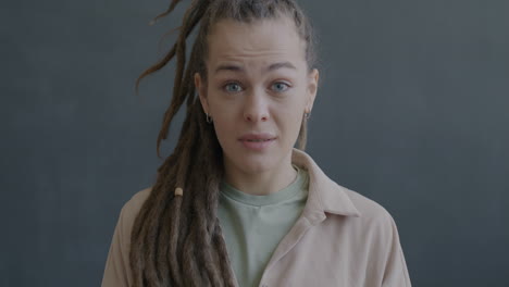 woman with dreadlocks expressing concern