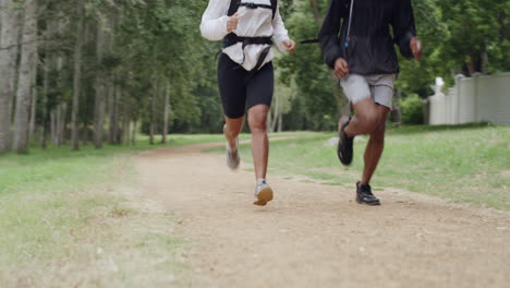 couple running through a forest trail