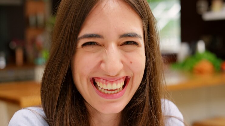 Woman laughing in a kitchen