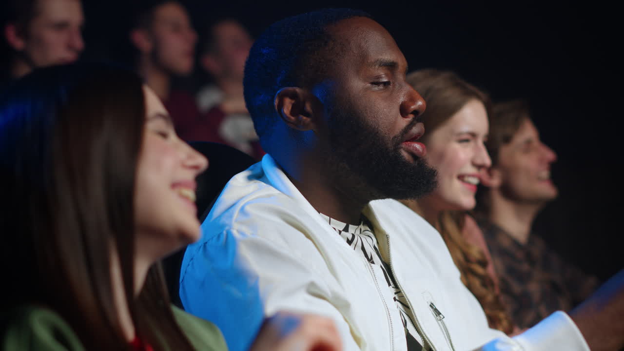 Joyful friends laughing in cinema