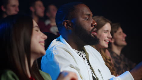 joyful friends laughing in cinema