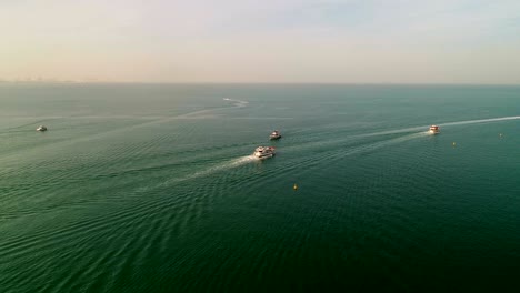 aerial view of group of yachts sailing in the persian gulf in dubai, u.a.e.