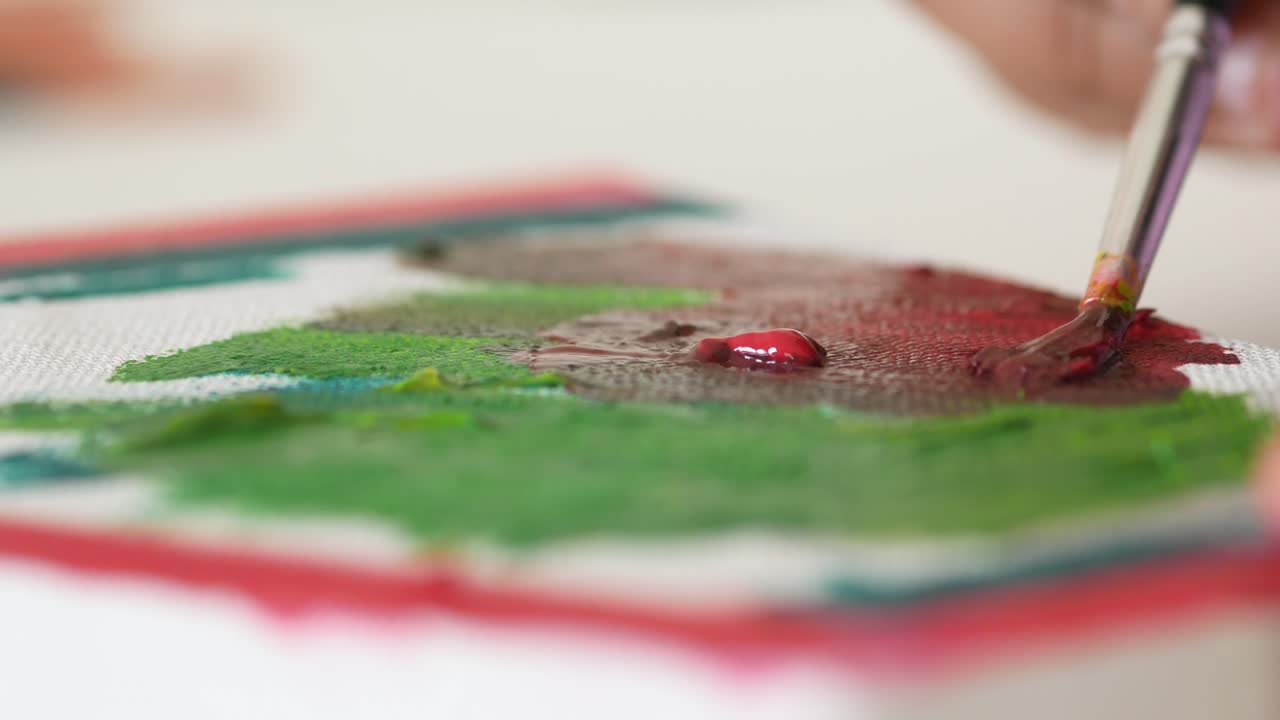 A child painting on a canvas