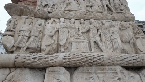 tilt up of the details of the reliefs on the arch of galerius, ruins of roman emperor, at thessaloniki,greece. no people.