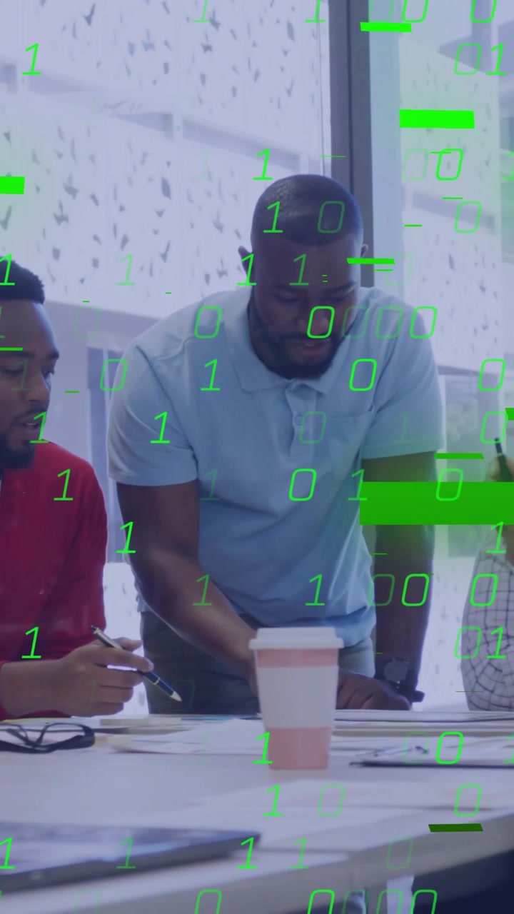 Vertical video: Lead pointing at papers in business, sparking binary overlay showing data obscuring
