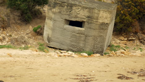 cement war bunker that has slid off its foundation