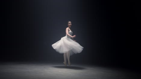 pretty ballerina spinning around on tiptoe. ballet dancer dancing on stage.