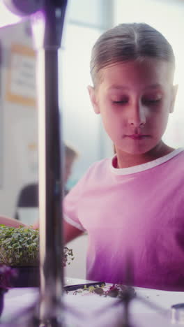 girl experimenting with microgreens in a science lab