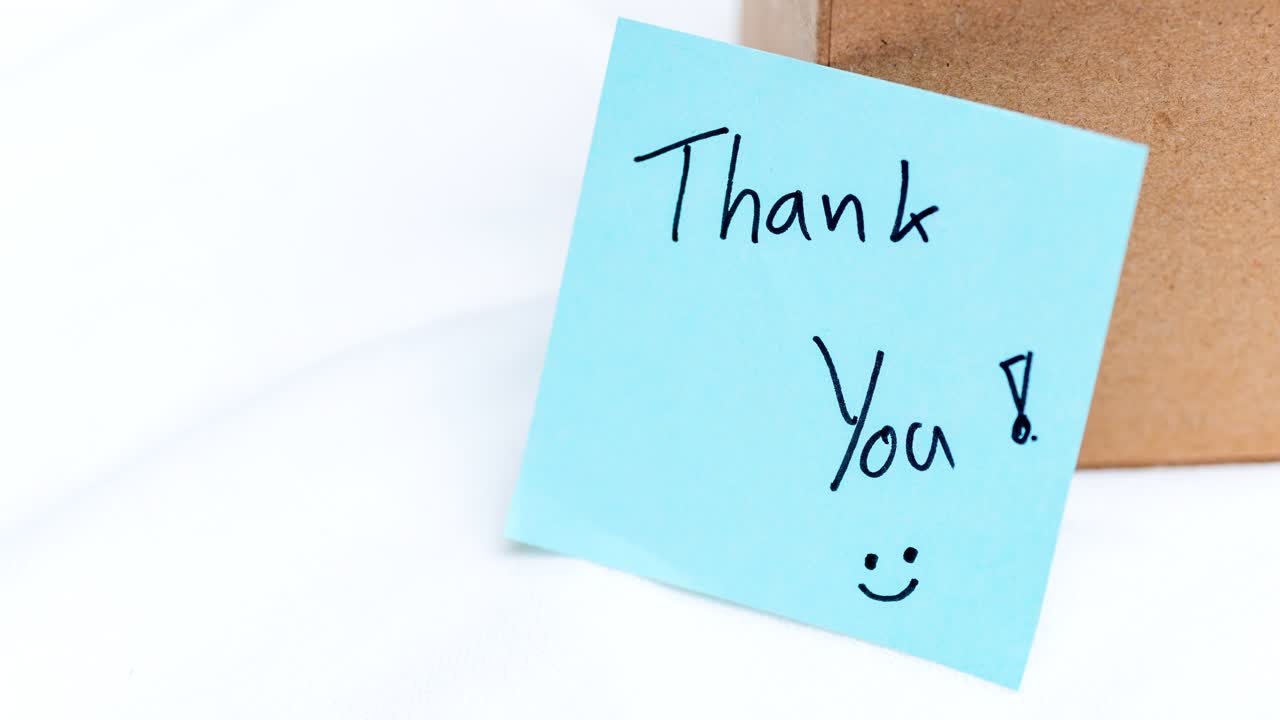 Zoom in gratitude thank you note a gift box home setting intimate perspective