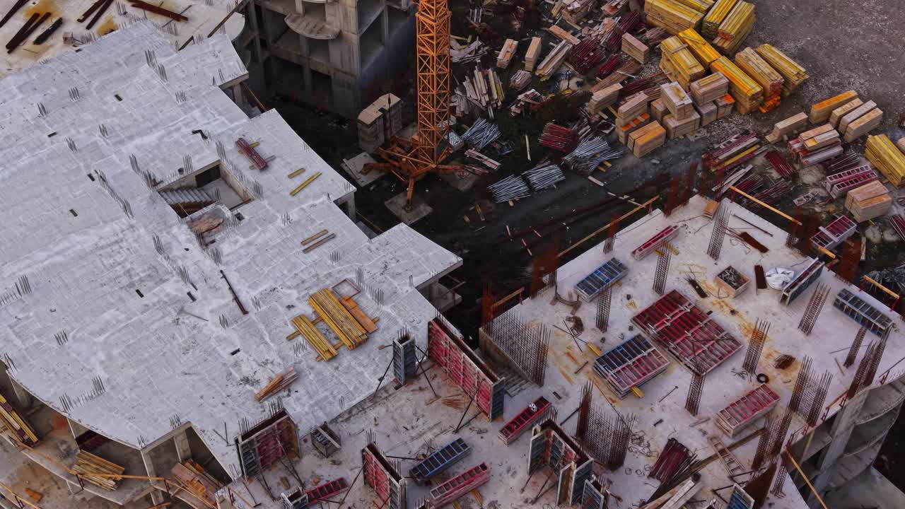 Construction site viewed from above with materials and equipment scattered