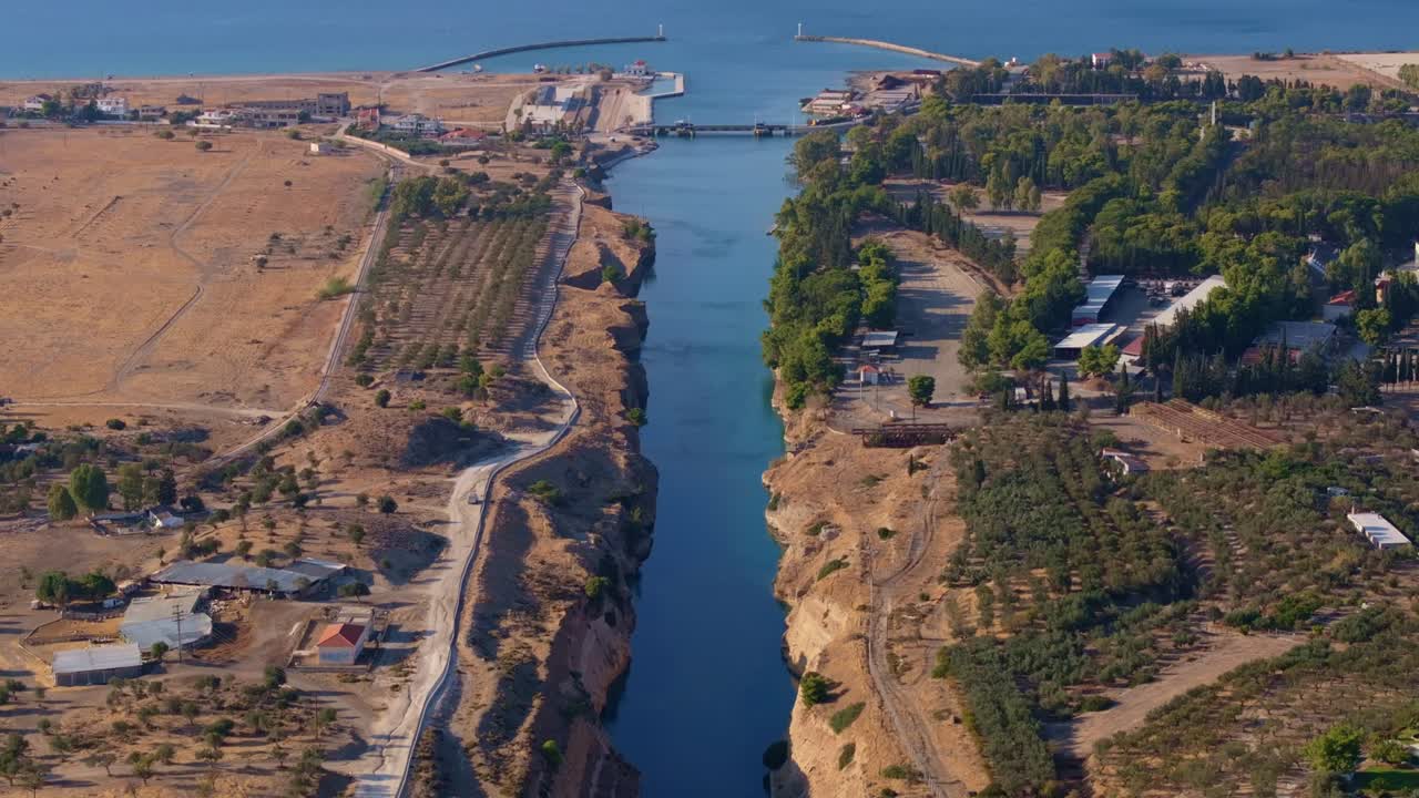 Aerial view of emerald canal winding through arid rock, Greece