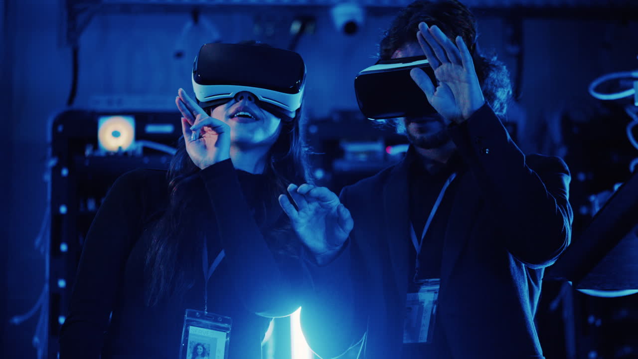 A man and a woman using Virtual Reality headsets in a server room