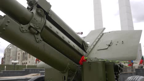 war memorial with cannon and flowers