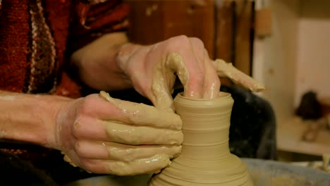 professional male potter working in workshop