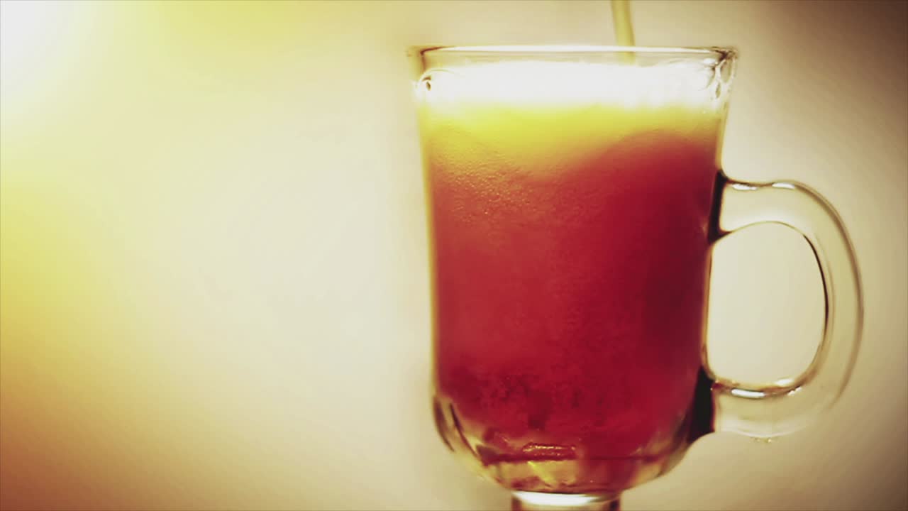 Cocktail being poured into a glass mug