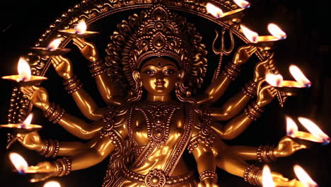 golden statue of durga with diyas