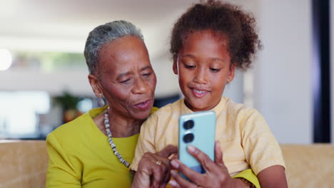 Love,-phone-and-grandmother-with-child-on-a-sofa