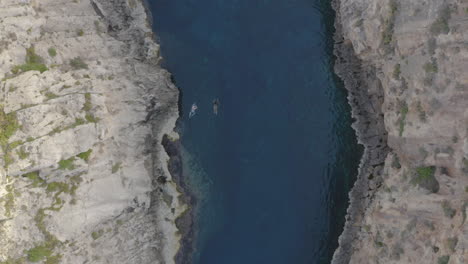 people swimming in the wied il-għasri sea canyon,malta,overhead shot