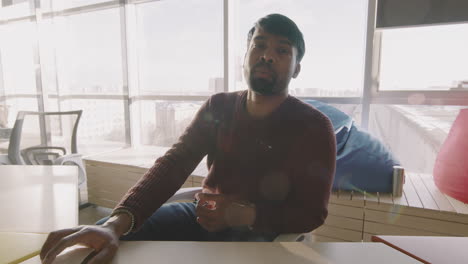 young businessman talking on video call in office