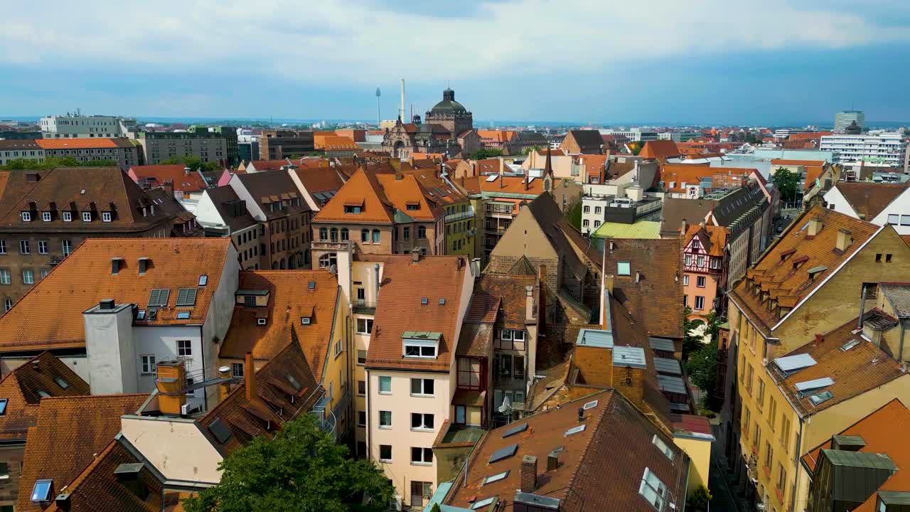 4K Aerial Drone Video of Copper-clad Cupolas, Church Spiers, and Tiled Rooftops of Buildings in Downtown Nurnberg, Germany