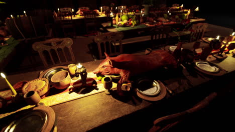 a grand feast featuring meats drinks and fruits at a candlelit gathering