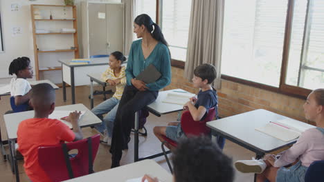 in school, teacher engaging with students raising hands in classroom discussion