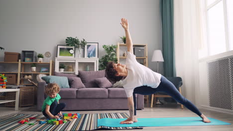 mother and son doing yoga together at home