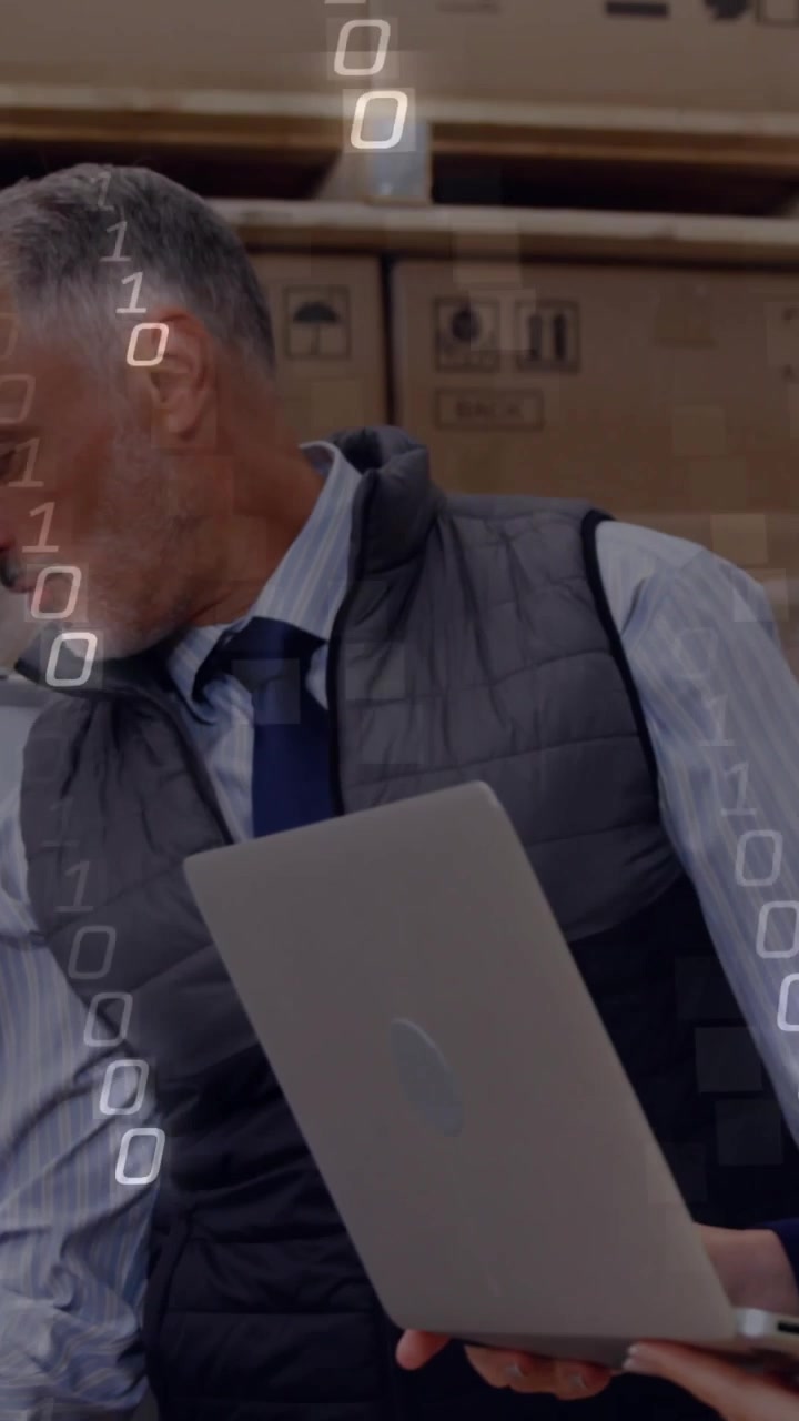 Vertical video: Laptop arriving, he pointing to board, she watching, binary overlay moving for plan