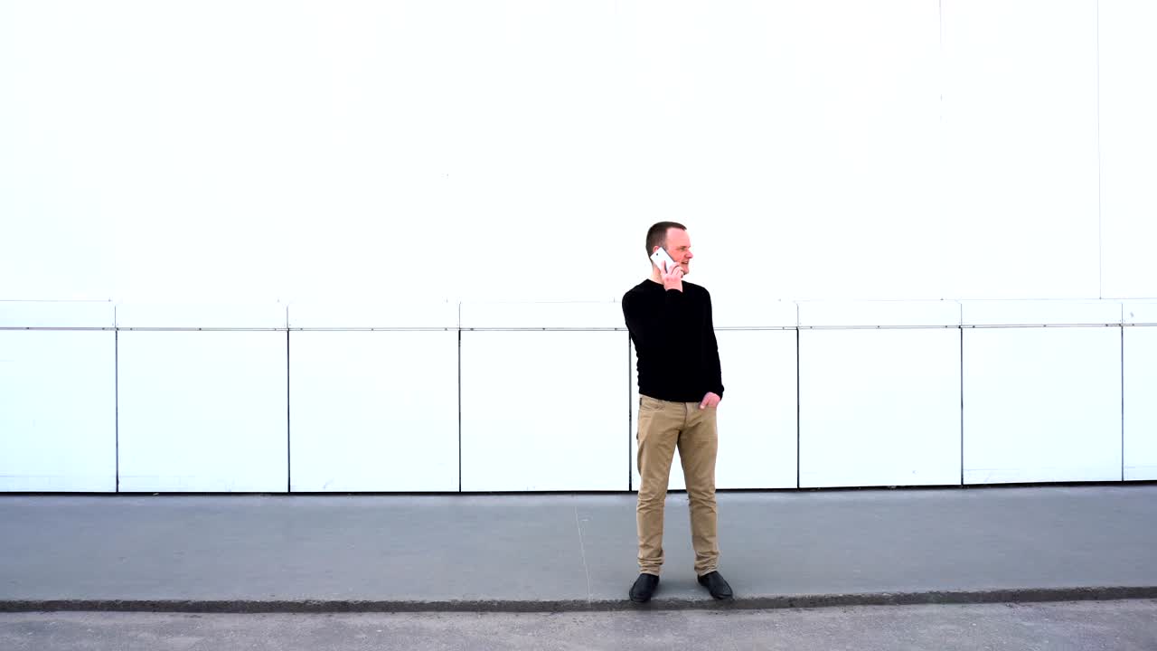 Man talking on cellphone and smiles