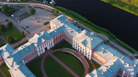 aerial view of jelgava palace and courtyard with surrounding river and trees