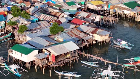 slum on wooden pillars, houses with metal sheet roofs. fishing village, community, coron, philippines.