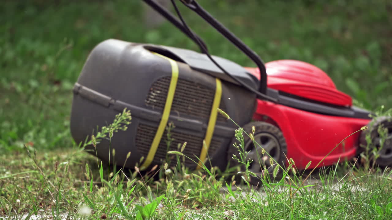 Man mowing the grass. Outdoor worker working on mowing the lawn