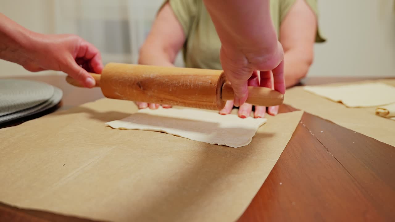 Family hands prepare pastry dough with care and tradition before baking