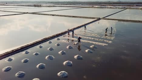drone view of workers collecting salt on salt fieldon hon khoi salt field, ninh diem town, khanh hoa province, central vietnam
