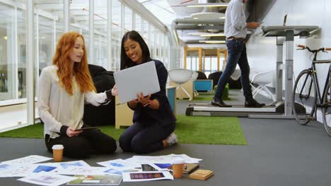 female executives discussing over laptop 4k