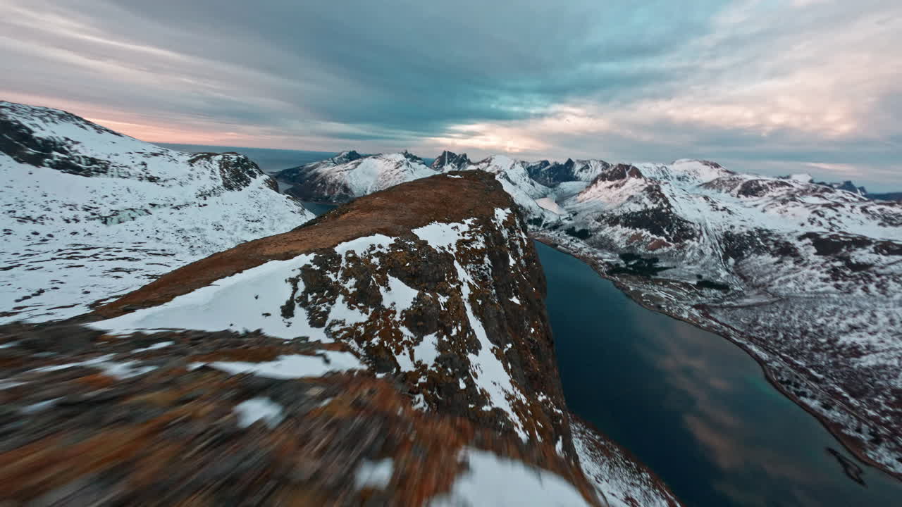 Snowy mountain ridge with dramatic sky over Senja Island, Norway
