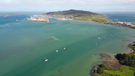 coastal town and white boats in bluff, new zealand, aerial drone view